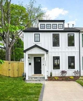 The same home after a two-level rear addition in Del Ray, Alexandria, with board-and-batten siding, dormers and a new front entry
